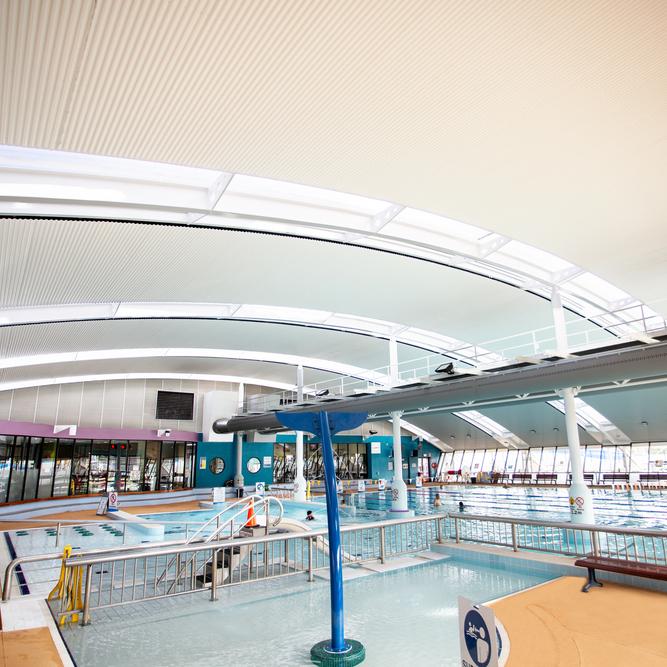 Aquatic centre with WAVELINE aluminium ceiling manufactured from PERMALITE aluminium in colour Glacier White